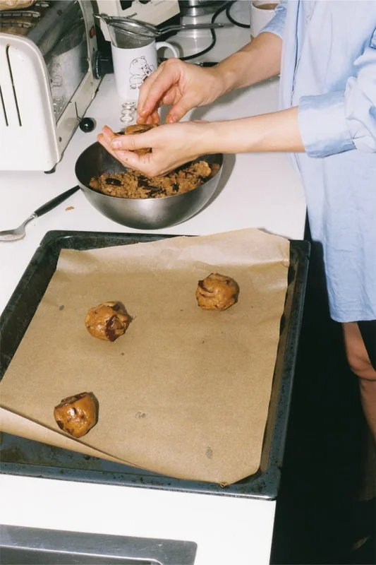 A home baker shaping freshly made cookies