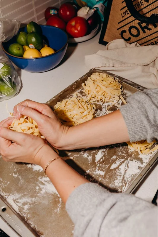 A home cook preparing fresh pasta by hand